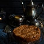 Eggless Dorset Apple Cake, on cake stand, with metal coffee pot in background, dark photo