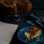 a slice of apple cake with recipe book